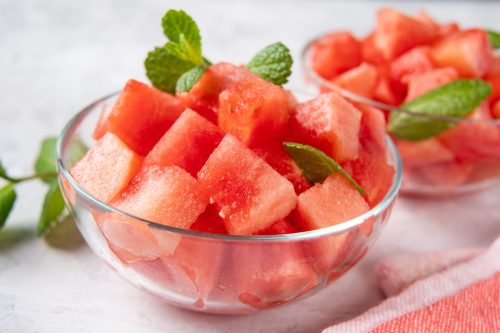 Crop shot of glass bowl with juicy and sweet watermelon cubes