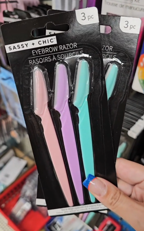 Shopper holding eyebrow razors at Dollar Tree