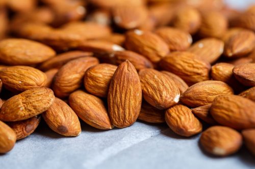 raw almonds on gray surface