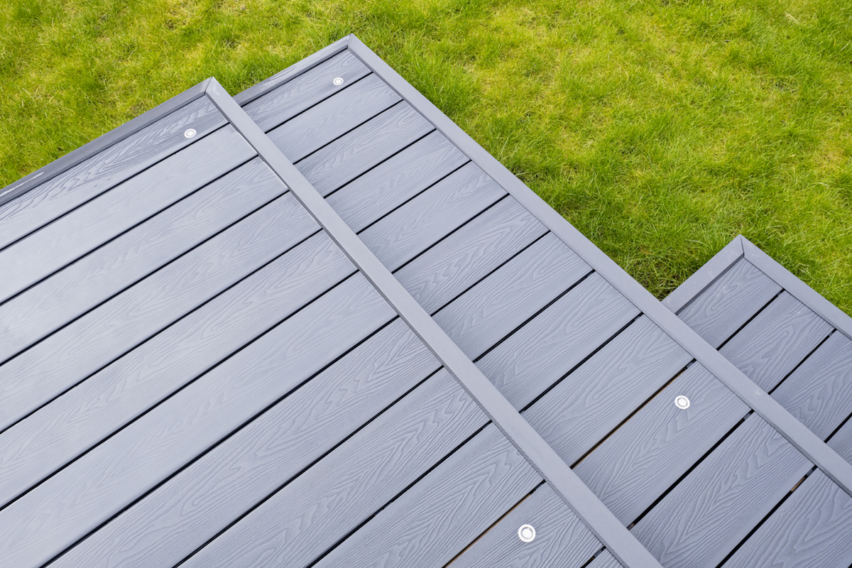 Newlly constructed decking over two levels with deck lighting installed and in Ash grey colour with summer house painted in the same matching colour.Good Image for a landscape Gardiner