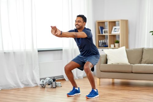 Man doing squats at home