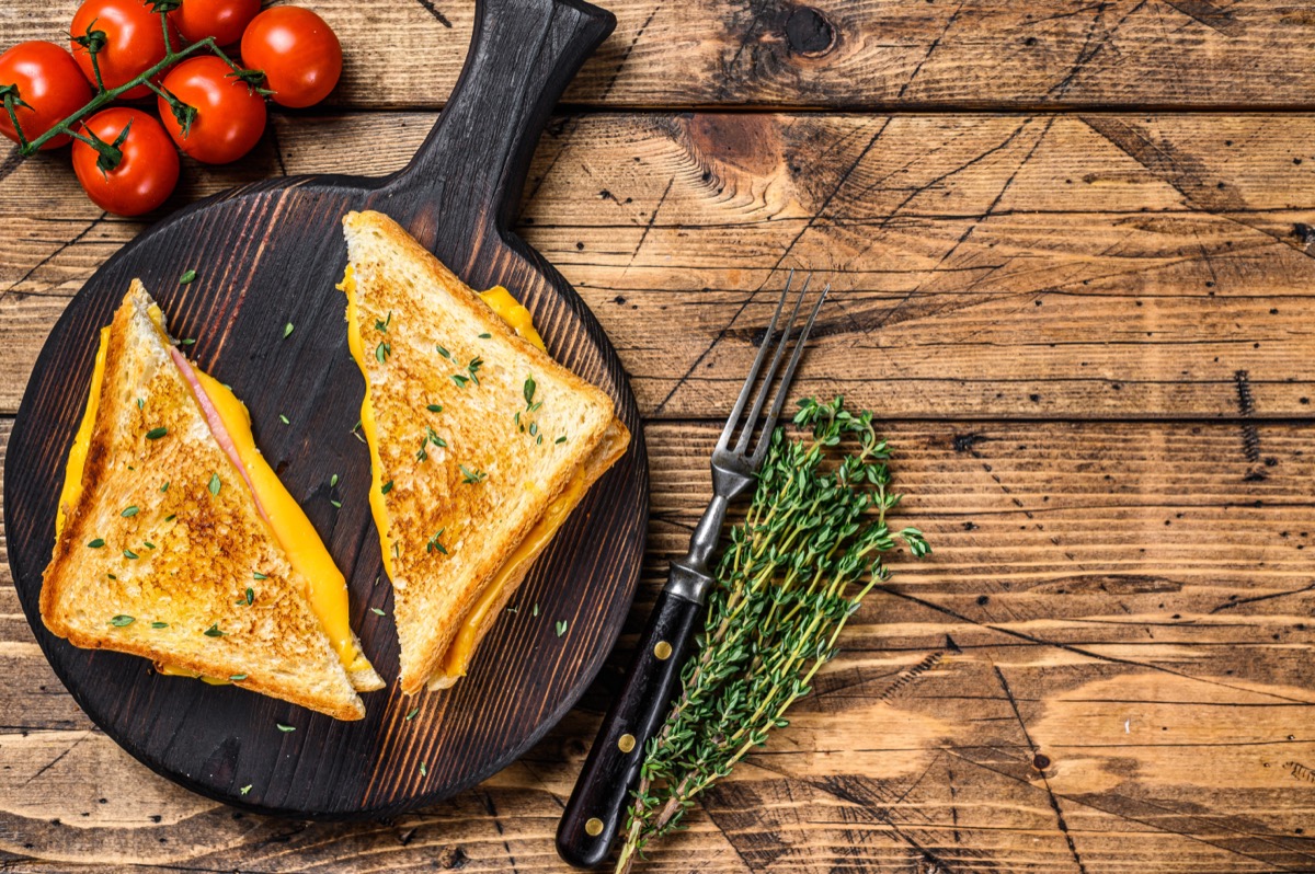 American ham and melted cheese sandwich. wooden background. 