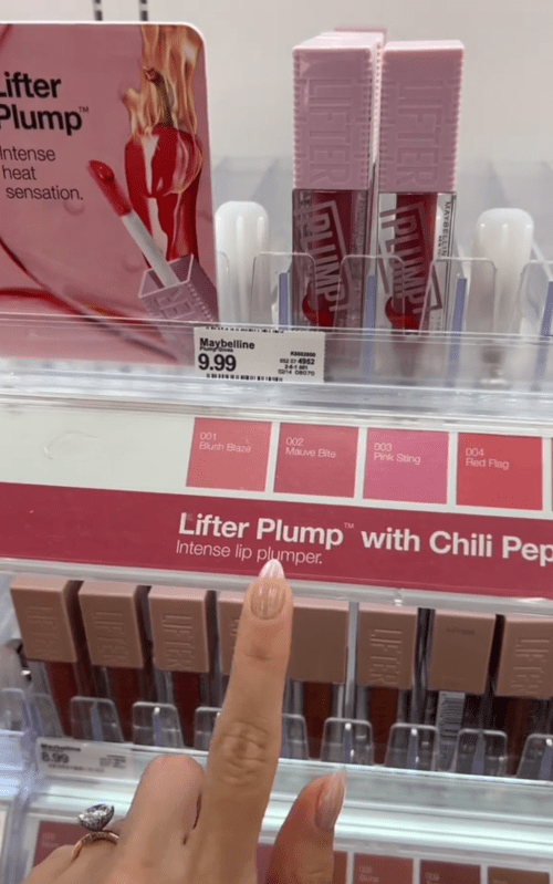 Shopper pointing to lip glosses at Target