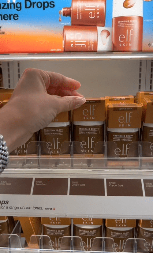 Shopper holding up bronzer at Target