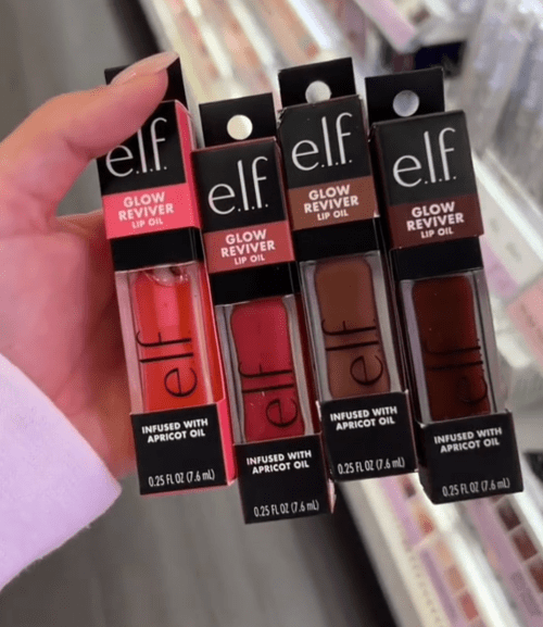 Shopper holding up e.l.f. lip balms at Target