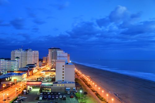 ocean front and buildings in downtown Virginia Beach, Virginia at dusk