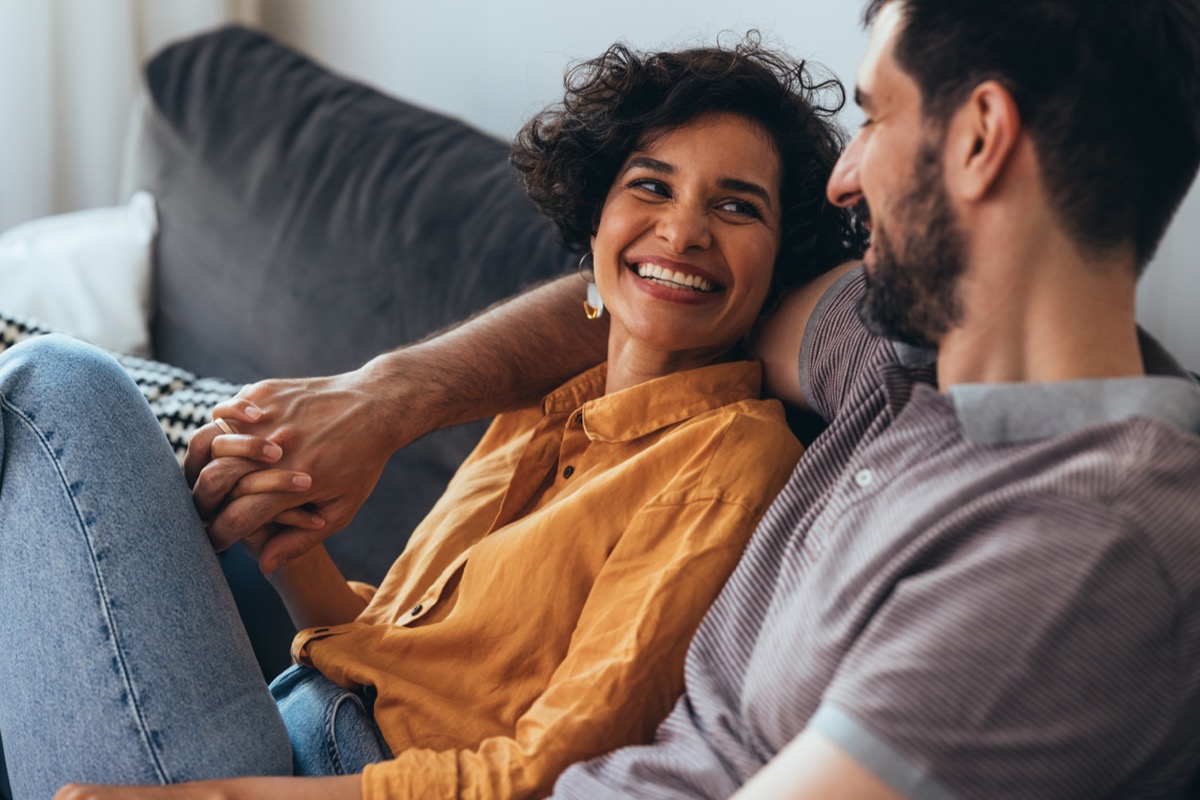 A smiling woman and her boyfriend enjoying spending their leisure time together.