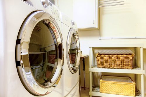 Old style laundry room with modern appliances and wicker baskets