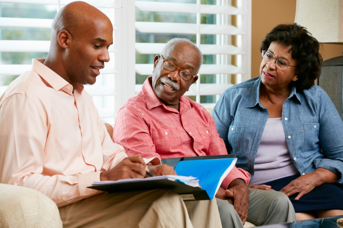 a mature couple meeting with their financial advisor