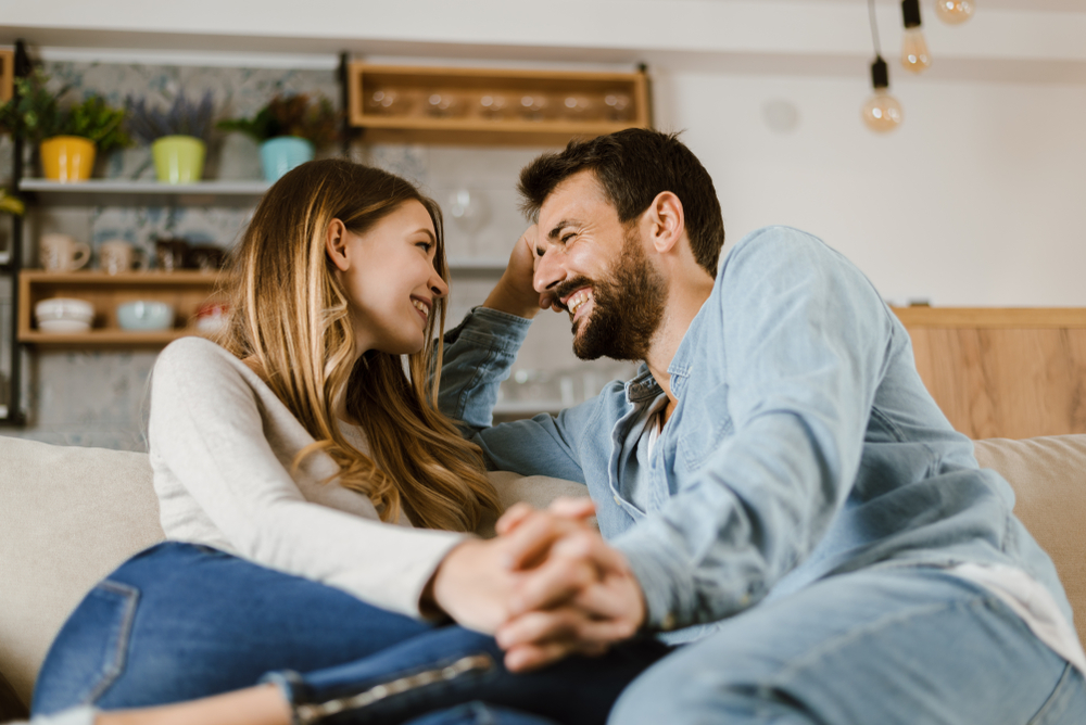 Happy couple talking on couch