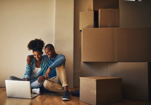 Happy couple, new home and laptop on floor for internet, research decor ideas and shopping in living room. Man, woman and technology for banking with bond payment, ecommerce or property investment