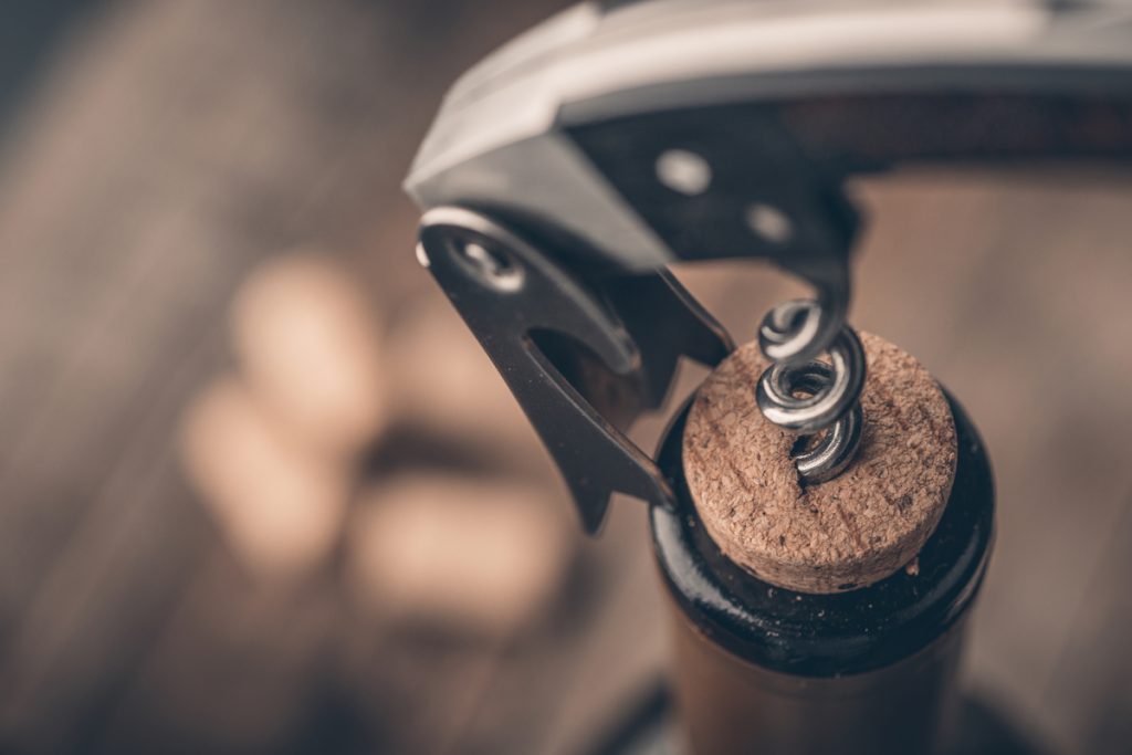 Opening a wine bottle with a corkscrew