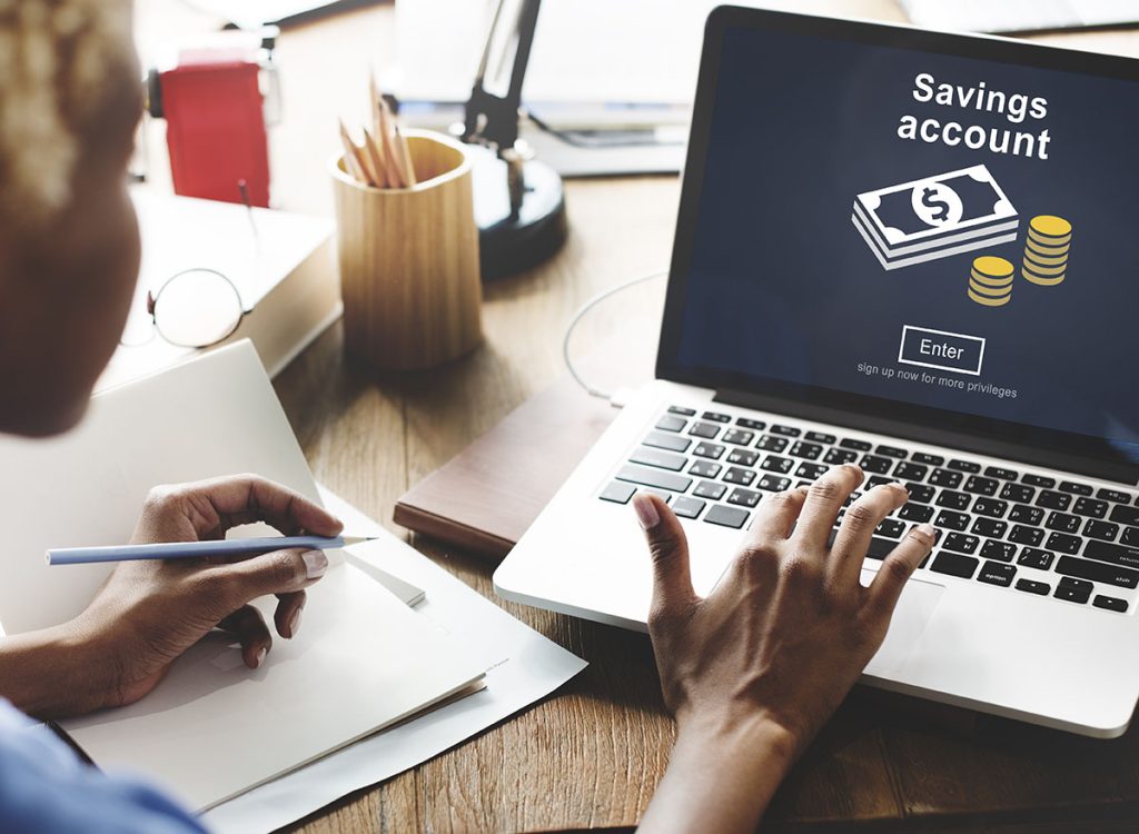 Person looking at savings account on laptop screen