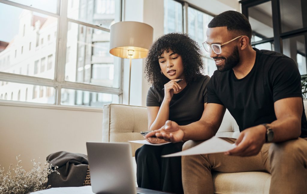 A young couple using a laptop to go over their finances