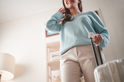 baggage, travel, woman, suitcase, trip, bag, case, holiday, suit, vacation. below angle view portrait of girl checking organizing wardrobe clothes wear for flight relocation voyage at her room.