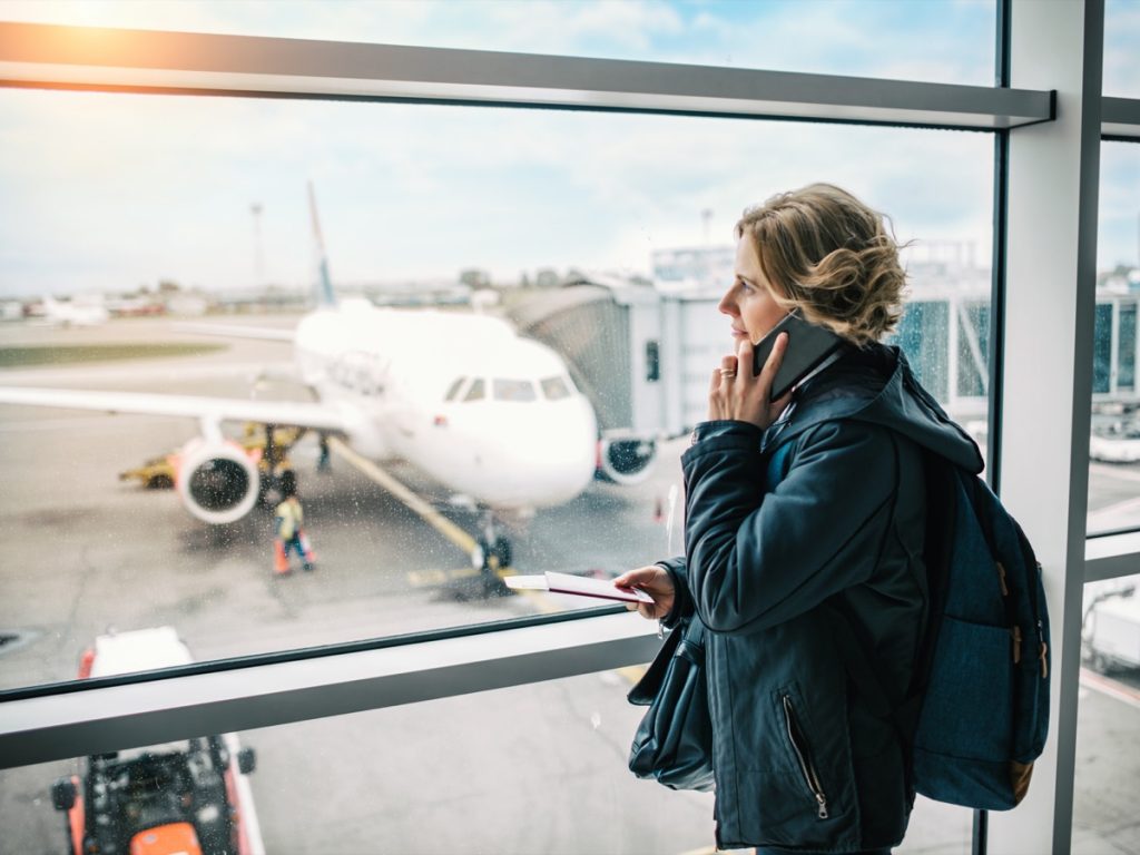 Woman using phone at the airport at the international airport