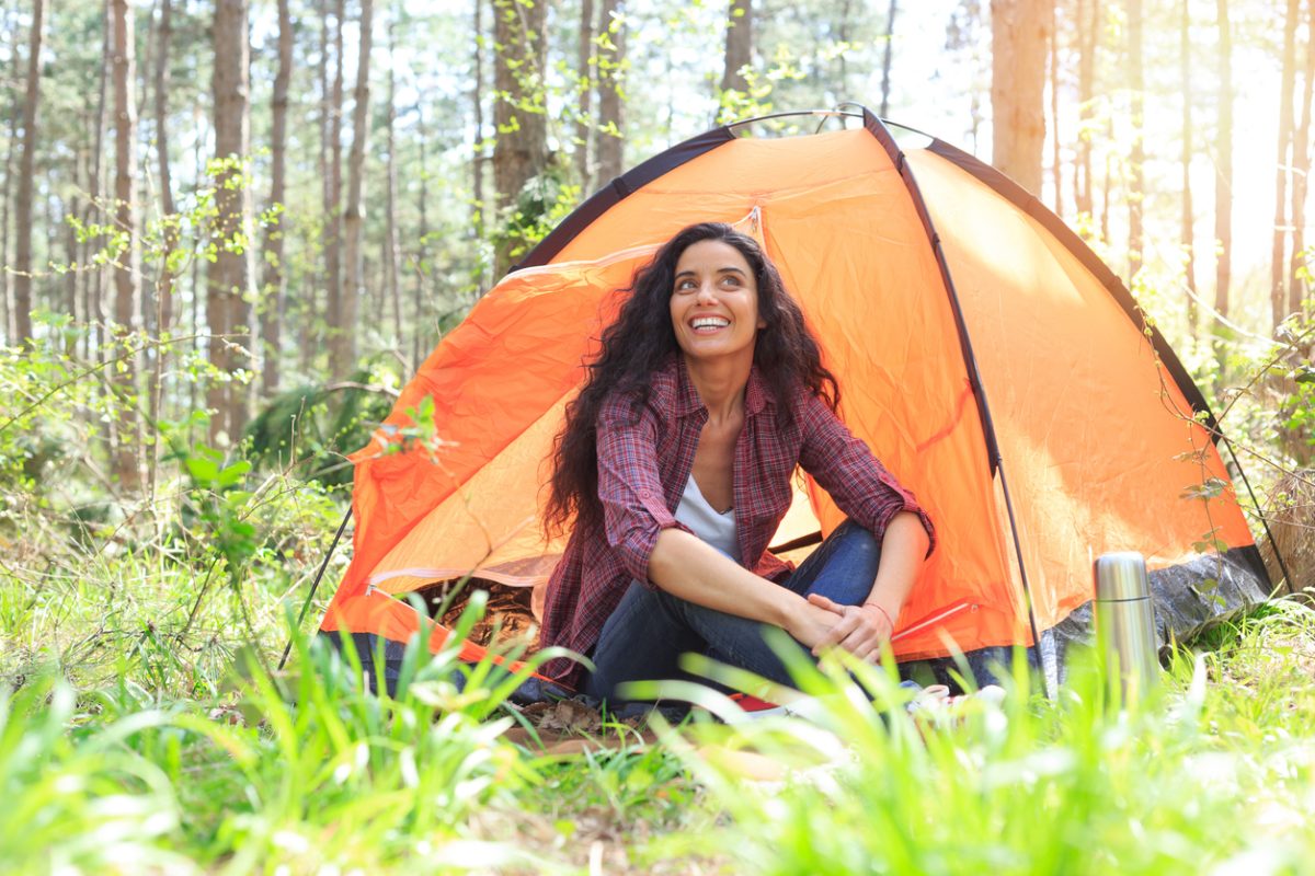 Young woman camping in the forest