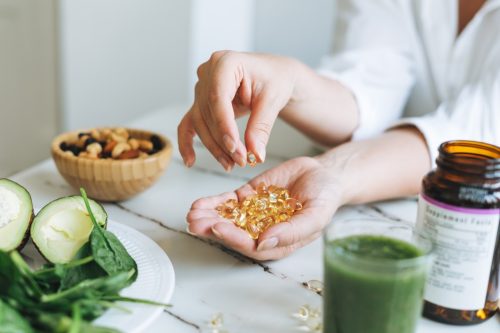 Woman Holding Vitamins