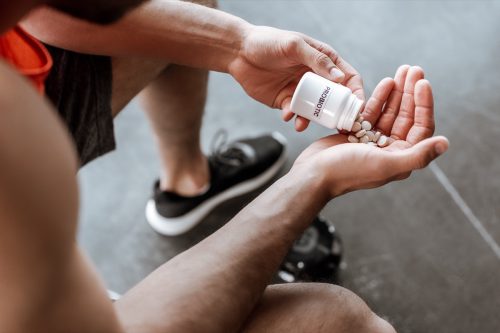 man taking probiotic pills