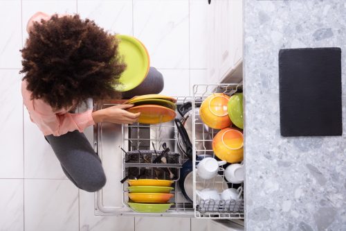 woman loading dishwasher,