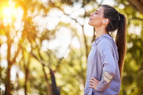 woman walking outside and embracing nature