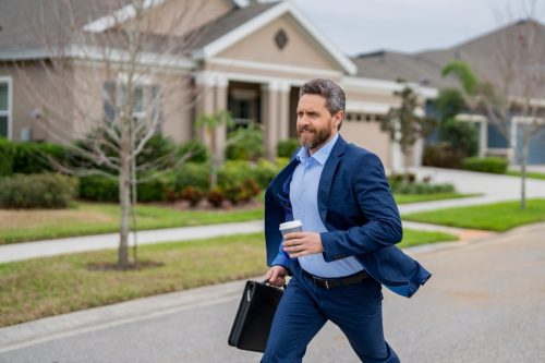 Business man with briefcase and take away coffee run outdoor. Businessman run down street, late meeting. Running business man. Fast business. Run and late business. Manager ceo run from home.