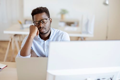 Tired overworked businessman sleeping at job in his office