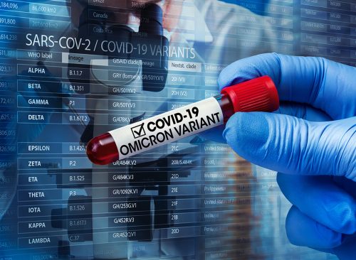 Researcher with blood sample of New Variant of the Covid-19 Omicron B.1.1.529 and generic data of covid-19 Coronavirus Mutations. Doctor in analysis lab holding sample of new strain of covid Omicron