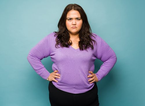 Angry annoyed obese woman looking frustrated while having problems making eye contact